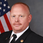 Portrait of Bro. Derrick Evans, a devoted Baptist pastor and former fire department captain, remembered for his faithful preaching and compassionate service to both church and community.